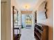 A bright entryway with a decorative mirror, coat rack, and tile flooring at 21444 Higgs Dr, Port Charlotte, FL 33952