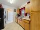 Kitchen featuring tile floors, wooden cabinets, and stainless steel appliances at 21444 Higgs Dr, Port Charlotte, FL 33952