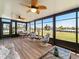 Inviting lanai featuring comfortable seating, ceiling fans, and panoramic views of the serene waterfront, perfect for relaxation at 21444 Higgs Dr, Port Charlotte, FL 33952
