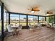 Bright and airy lanai featuring comfortable seating and dining areas, ideal for enjoying the serene waterfront views and outdoor living at 21444 Higgs Dr, Port Charlotte, FL 33952