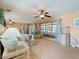 Bright living room featuring tile floors, ceiling fan, and sliding glass doors at 21444 Higgs Dr, Port Charlotte, FL 33952