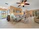 Open concept living room with tile floors, flamingo pillows, and plenty of natural light at 21444 Higgs Dr, Port Charlotte, FL 33952