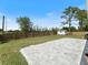 Backyard features a large concrete tile patio, a green lawn, and a shed for storage at 22010 Seyburn Ter, Port Charlotte, FL 33954