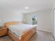 Bright bedroom features light hardwood floors, and a large window that provides lots of natural light at 22010 Seyburn Ter, Port Charlotte, FL 33954
