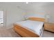 Bright bedroom features light hardwood floors, and two nightstands on either side of the bed at 22010 Seyburn Ter, Port Charlotte, FL 33954