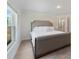 Bright bedroom with a serene atmosphere boasts a large window and an ensuite bathroom with glass-enclosed shower at 22010 Seyburn Ter, Port Charlotte, FL 33954