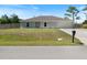 Charming single-story home with a well-manicured lawn and an attached two-car garage at 22010 Seyburn Ter, Port Charlotte, FL 33954