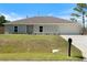 Charming single-story home with a well-manicured lawn and a two-car attached garage, providing curb appeal at 22010 Seyburn Ter, Port Charlotte, FL 33954