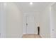 Inviting foyer with a clean white door, neutral walls, and light-colored floors, offering a welcoming entrance at 22010 Seyburn Ter, Port Charlotte, FL 33954