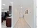 Long hallway with modern flooring, recessed lighting, and access to the kitchen at 22010 Seyburn Ter, Port Charlotte, FL 33954