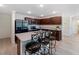 An inviting kitchen features dark cabinetry, stainless steel appliances, and a convenient breakfast bar with seating at 22010 Seyburn Ter, Port Charlotte, FL 33954