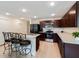 Well-lit kitchen features modern stainless steel appliances, sleek countertops, and an island with bar stool seating at 22010 Seyburn Ter, Port Charlotte, FL 33954