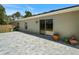 Back patio featuring a large concrete tile patio, gray exterior and a sliding glass door at 22010 Seyburn Ter, Port Charlotte, FL 33954