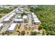 Aerial view showcasing a pool, tennis court, bocce ball, landscaping, parking, and nearby waterway of the community at 22375 Edgewater Dr # 255, Punta Gorda, FL 33980