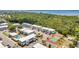 Aerial view featuring a pool, tennis court, bocce ball, landscaping, parking, and nearby waterway of the community at 22375 Edgewater Dr # 255, Punta Gorda, FL 33980