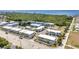 An aerial view shows the property with a pool, tennis court, bocce ball, landscaping, parking, and nearby waterway at 22375 Edgewater Dr # 255, Punta Gorda, FL 33980