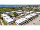 Aerial view of the condo community featuring a pool, tennis court, bocce ball, lush landscaping, and convenient parking at 22375 Edgewater Dr # 255, Punta Gorda, FL 33980