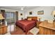 This bedroom features hardwood floors, an adjacent sunroom, and a large dresser with ample drawer space at 22375 Edgewater Dr # 255, Punta Gorda, FL 33980