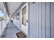 Exterior condo corridor featuring the front door, window, and light blue siding at 22375 Edgewater Dr # 255, Punta Gorda, FL 33980