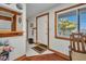 Entryway with wood trim, tile flooring, coat rack, and bright natural light at 22375 Edgewater Dr # 255, Punta Gorda, FL 33980