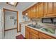Bright kitchen featuring wood cabinets and a stainless steel sink at 22375 Edgewater Dr # 255, Punta Gorda, FL 33980
