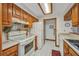 Functional kitchen with white appliances, tile floors, and wooden cabinets at 22375 Edgewater Dr # 255, Punta Gorda, FL 33980