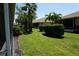 Spacious backyard features lush green grass, trimmed shrubs and privacy landscaping at 24141 Green Heron Dr # 23, Punta Gorda, FL 33980
