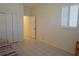 Bright bedroom with white shuttered window and closet; neutral tile floor at 24141 Green Heron Dr # 23, Punta Gorda, FL 33980