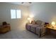 Comfortable bedroom features a daybed with red and white patterned cover and wicker furniture at 24141 Green Heron Dr # 23, Punta Gorda, FL 33980