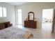 Bedroom with tile floors, dresser and access to patio at 24141 Green Heron Dr # 23, Punta Gorda, FL 33980