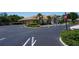 Exterior shot of clubhouse with manicured landscaping and ample parking at 24141 Green Heron Dr # 23, Punta Gorda, FL 33980