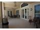 Spacious covered patio featuring ceiling fan, dining table set, additional seating, and tiled floor at 24141 Green Heron Dr # 23, Punta Gorda, FL 33980