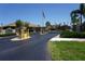 Gated community entrance with stone pillars and an American flag at 24141 Green Heron Dr # 23, Punta Gorda, FL 33980