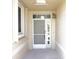 Covered front entry with a white screen door and sidelight at 24141 Green Heron Dr # 23, Punta Gorda, FL 33980