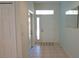 Bright foyer with tile flooring and a white front door with glass panels at 24141 Green Heron Dr # 23, Punta Gorda, FL 33980