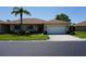 Charming single-story home featuring a well-manicured lawn and an attached two-car garage at 24141 Green Heron Dr # 23, Punta Gorda, FL 33980