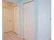 Hallway with two white paneled doors, providing convenient access to different areas of the home at 24141 Green Heron Dr # 23, Punta Gorda, FL 33980