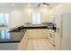 Bright kitchen features white cabinetry, black countertops, and stainless steel appliances at 24141 Green Heron Dr # 23, Punta Gorda, FL 33980
