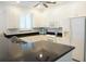 Kitchen features white cabinetry, black granite countertops and stainless steel appliances at 24141 Green Heron Dr # 23, Punta Gorda, FL 33980