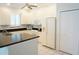 Bright kitchen with white cabinets, black countertops, and modern appliances at 24141 Green Heron Dr # 23, Punta Gorda, FL 33980