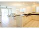 Open concept with an island, white cabinets and countertops, with tile floors and plenty of natural light at 24141 Green Heron Dr # 23, Punta Gorda, FL 33980