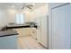 Kitchen with white appliances, ample cabinet space, and tile flooring at 24141 Green Heron Dr # 23, Punta Gorda, FL 33980