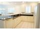 Spacious kitchen with white cabinetry, black countertops and stainless steel appliances at 24141 Green Heron Dr # 23, Punta Gorda, FL 33980