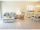 Inviting living room with a comfortable sofa, rocking chair, and bright natural light creating a cozy ambiance at 24141 Green Heron Dr # 23, Punta Gorda, FL 33980