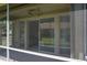 View from enclosed patio to sliding glass doors overlooking well-kept lawn at 24141 Green Heron Dr # 23, Punta Gorda, FL 33980