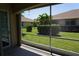 Screened patio offers a tranquil view of the manicured backyard and neighboring homes at 24141 Green Heron Dr # 23, Punta Gorda, FL 33980