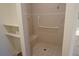 Accessible shower with a built-in seat, safety bar, and tiled walls for a safe and comfortable bathing experience at 24141 Green Heron Dr # 23, Punta Gorda, FL 33980