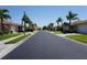 A straight-on view down a perfectly paved community street at 24141 Green Heron Dr # 23, Punta Gorda, FL 33980