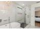 The bright bathroom features a glass enclosed shower and a chandelier over a soaking tub at 2427 Carnation Ct, North Port, FL 34289