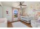 Sweet Bedroom with crib, mural, and decorations at 2427 Carnation Ct, North Port, FL 34289
